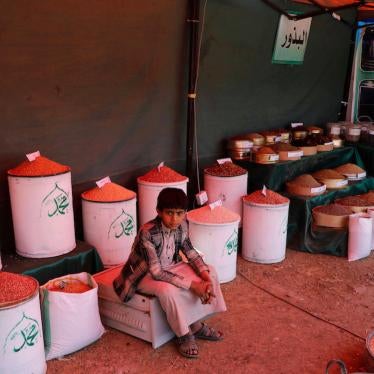 A Yemeni boy sits in a dry goods shop in a traditional market in Sanaa, Yemen.