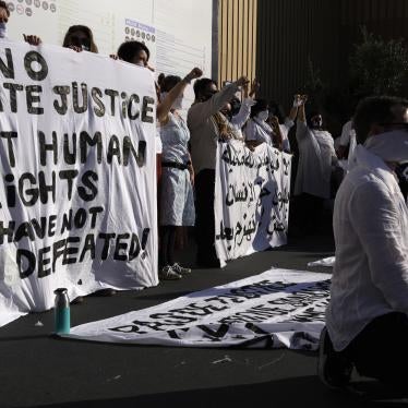 Demonstrators participate in a silent protest at the COP27.