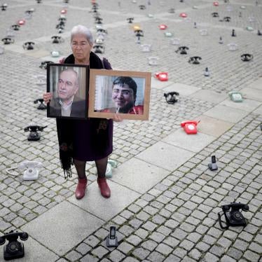 Fadwa Mahmoud holds portraits of her son and husband, who disappeared in Syria in 2012, in Berlin, Germany. 