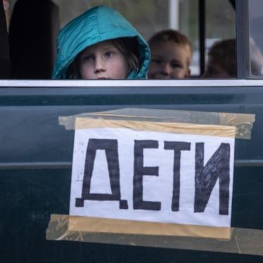 Children from Mariupol, Ukraine, look out the window of their family’s car, marked with the word “children,” after arriving at an evacuation point for people fleeing areas under Russian control.