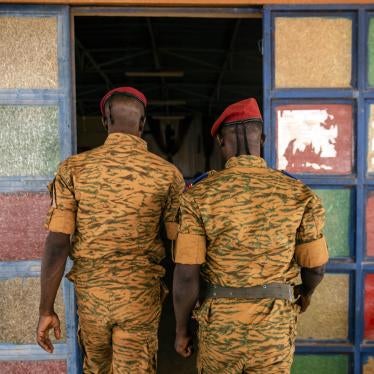 Two uniformed soldiers walk into a church
