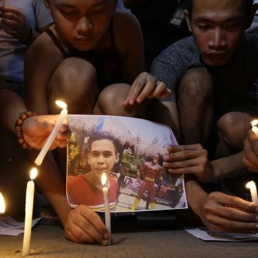 Activists light candles in front of the picture of 17-year-old student Kian delos Santos in Caloocan City, Philippines on November 29, 2018.