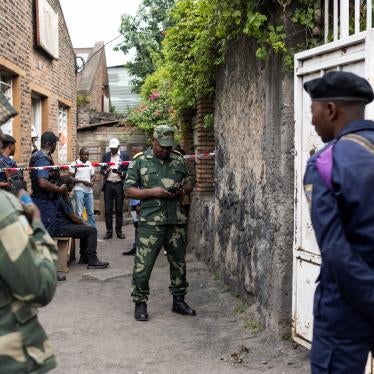 Congolese soldiers stand guard as prospective voters gather to register with the electoral commission in Goma, Democratic Republic of Congo.