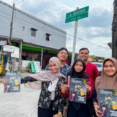 Student journalists pose under a street sign in Pekanbaru, Riau, named for their magazine, Bihana, which played an important role in 1998 when local groups sought a bigger say in their province after President Suharto’s authoritarian rule.