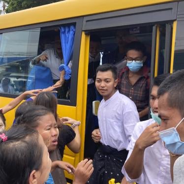 Prisoners get off a bus after their release from Insein Prison