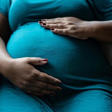  Pregnant woman touching her belly. 