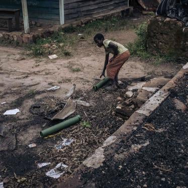 A boy collects mortar casings in the remains of a school building used as a base and allegedly destroyed by M23 fighters in Kishishe, North Kivu, Democratic Republic of Congo, April 5, 2023.
