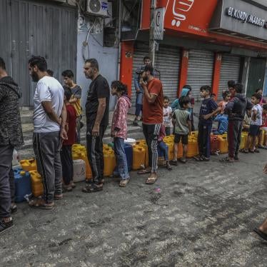 Palestinians stand in line to get water in the city of Rafah in the southern Gaza Strip amid ongoing hostilities between Israeli forces and Palestinian armed groups, November 13, 2023. 