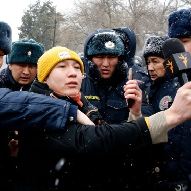 Police officers detain a journalist covering a protest near the government building in Bishkek, Kyrgyzstan, January 10, 2023. Protesters demanded the release of detained members of the so-called Kempir-Abad reservoir support committee.