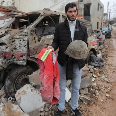 A man carries belongings of a paramedic killed at a paramedic center hit on March 27, 2024, by an Israeli airstrike in Habbarieh, southern Lebanon, March 27, 2024. 