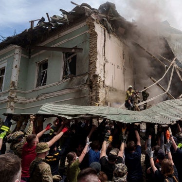 Workers remove debris from a destroyed hospital 