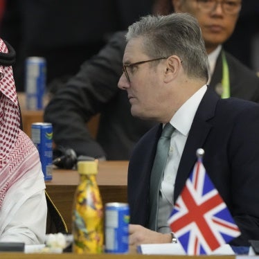 Saudi Arabia's Foreign Minister Prince Faisal bin Farhan Al-Saud (L) and Britain's Prime Minister Keir Starmer talk during the G20 Summit leaders meeting in Rio de Janeiro, November 18, 2024. 