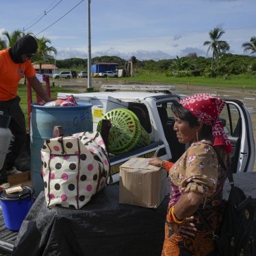 Civil protection officials, left, load a family's belongings on a truck to move from the island of Gardi Sugdub, located off Panama's Caribbean coast, to Nuevo Carti on the mainland, June 5, 2024.