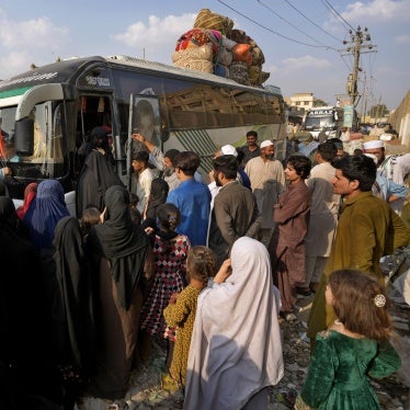 People board a bus to depart for Afghanistan, in Karachi, Pakistan, October 31, 2023.