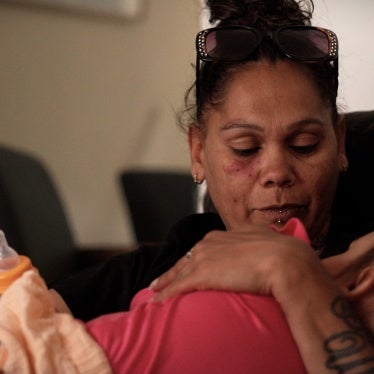 A woman cradles a toddler 