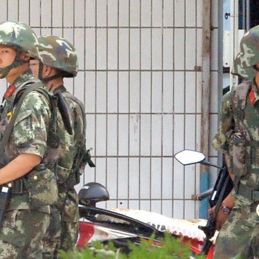 Armed Chinese police officers patrol on the street