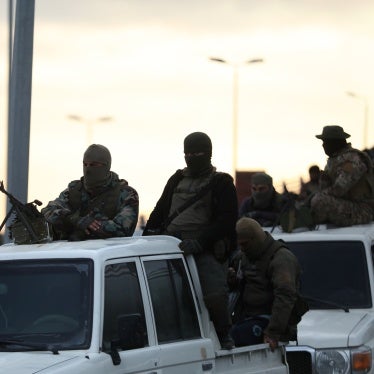 Fighters with the new Syrian government ride in trucks in Tartus, Syria, March 7, 2025, 