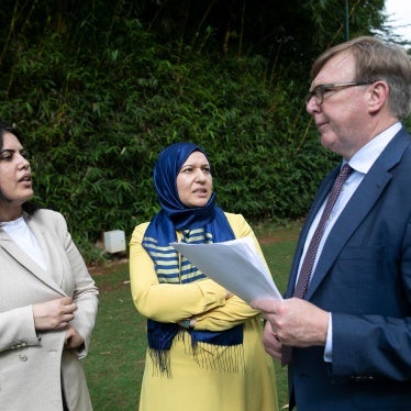 Yusra Ghannouchi (C) and Kaouther Ferjani (L), the daughters of prominent Tunisian detainees, are photographed with their lawyer, British barrister Rodney Dixon.