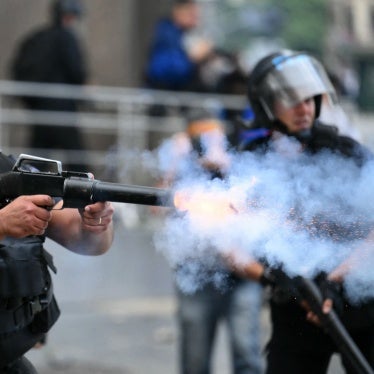 A riot police officer shoots a tear gas canister at protesters during a demonstration of pensioners calling for improvements to their pensions and access to free medicines, among other demands, in Buenos Aires on March 12, 2025.