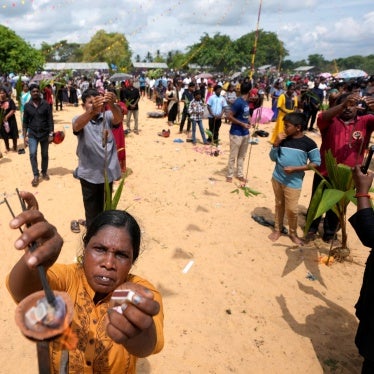 People perform rituals in memory of their deceased or missing relatives on a beach