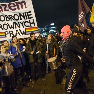 Activists raise a banner at a protest