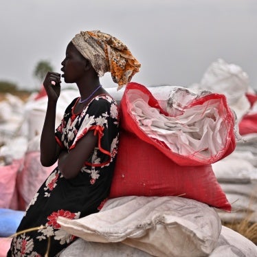 A villager who had volunteered to fetch gunny bags containing food rations from the site of an air drop takes a break at a village in Ayod county, South Sudan, February 6, 2020.