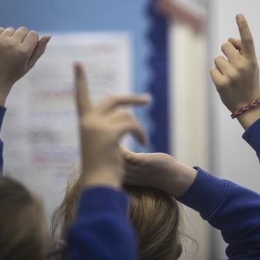 Raised hands in a classroom