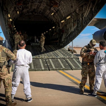 The first US military aircraft to carry detained migrants to a detention facility at Guantanamo Bay is boarded from an unspecified location in the US, February 4, 2025.