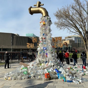 A prop depicting a water tap with cascading plastic bottles is displayed by activists near the Shaw Centre venue of negotiations for the global plastics treaty, in Ottawa, Canada, April 23, 2024.