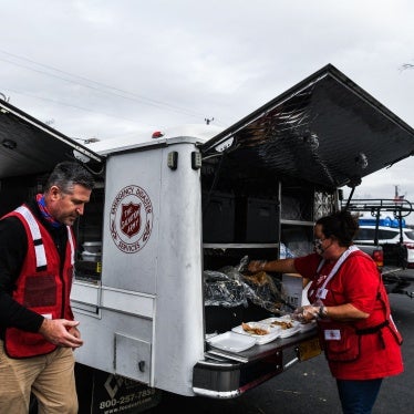 Director of Divisional Emergency Response of the Salvation Army William Trueblood (L) distributes food outside the Cayce United Methodist Church in Cayce, Kentucky, US, December 15, 2021, five days after tornadoes hit the area. 