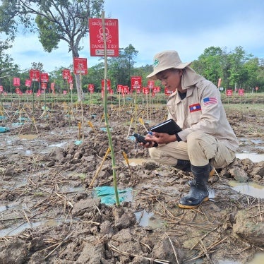 In Paksong district of Saravane province, Laos, a clearance technician from Norwegian People’s Aid uses a GPS device to record the coordinates of cluster munition remnants in a rice field where 178 BLU-26 submunitions were found. 