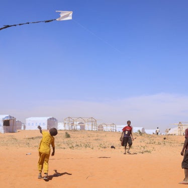 Sudanese refugee children from Darfur fly a handmade kite inside the Touloum refugee camp in Wadi Fira province, eastern Chad, November 30, 2025.