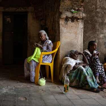 Women sit knitting