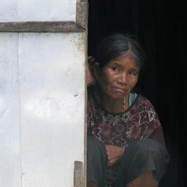 An elderly Montagnard woman sits at the door of a “house church” in Kret Krot village in Vietnam’s Central Highlands on September 26, 2013.
