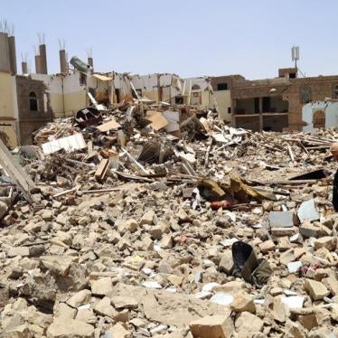 A neighbor, Ayed Ayed Kamil, stands amid the rubble of the destroyed al-Ibbi family home. © 2015 Ole Solvang/Human Rights Watch 