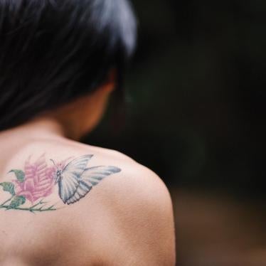 Jina, a 22-year-old transgender woman, sports a tattoo of a butterfly—a transgender symbol signifying transformation. 