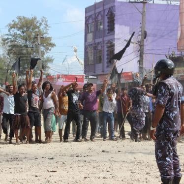 A police officer faces protesters in Nepal’s Terai region in September 2015.
