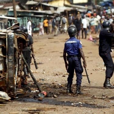 Guinea security forces try to disperse the crowd at the junction of Matoto where shops were burnt and looted after Friday's clashes between supporters of President Alpha Conde and his main election rival Cellou Dalein Diallo, in Conakry, Guinea on October