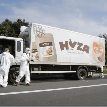 Forensic police officers inspect a parked truck in which up to 50 migrants were found dead, on a motorway near Parndorf, Austria August 27, 2015