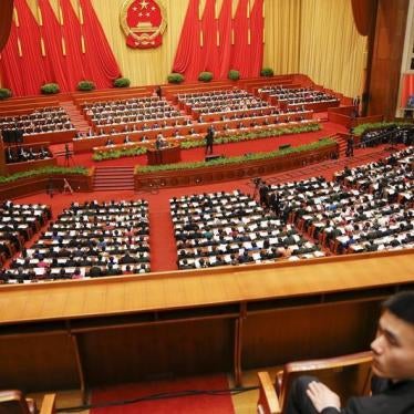 A security officer sits guard as Chinese Premier Li Keqiang gives a speech during the opening session of the National People's Congress (NPC) at the Great Hall of the People, in Beijing, China, March 5, 2016.