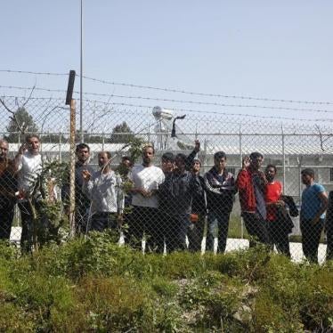 Migrants look through a fence from inside the Moria registration centre for refugees and migrants on the Greek island of Lesbos, Greece April 4, 2016. 
