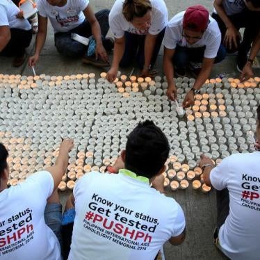 Campaign supporters lights on around 1,638 candles representing the number of dead victims claimed by HIV/AIDS in the Philippines since 1984 as part of their commemoration of International AIDS Candlelight Memorial Day in Quezon city, metro Manila in the 