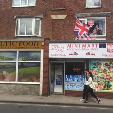A man and a woman walk past a Polish shop in Boston, Britain June 27, 2016.