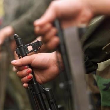 A Colombian guerilla woman holds her AK-47 as she takes part in a line of rebels during an army parade of fighters of the FARC in Villa Colombia camp near San Vicente del Caguan, Caqueta province, April 29, 1999. 