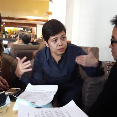 Kanza Vina (left), a transgender woman, talks with Abhipraya Ardiansyah (far right), a transgender man, and Yuli Rustinawati (center), their colleague from Forum LGBTIQ Indonesia. Vina and Abhipraya received awards from an independent journalism union.