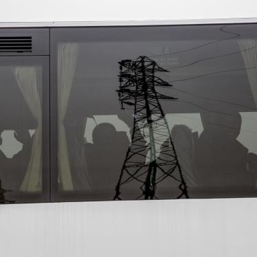 Former camp residents wave as they depart in buses for migrant centers elsewhere in France. 24 October 2016.