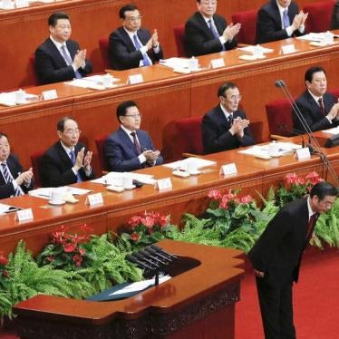 Zhou Qiang, chief of China's Supreme People's Court, bows during a session of the National People's Congress (NPC) in Beijing on March 13, 2016.