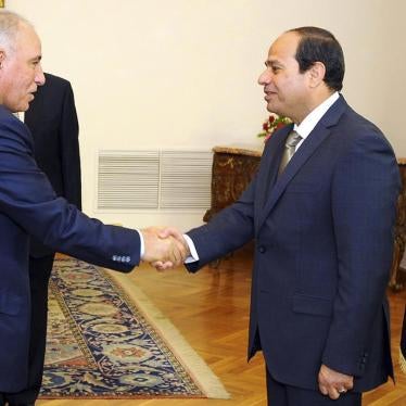 Egyptian President Abdel-Fattah el-Sissi, right, shakes hands with newly-appointed Justice Minister Ahmed el-Zind during a swearing-in ceremony in Cairo, Egypt on May 20, 2015. 