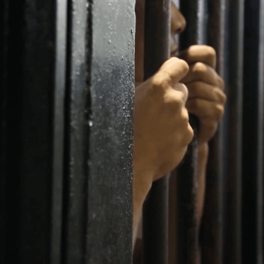 A man behind bars at Sfax detention center, Tunisia, on September 26, 2013. 