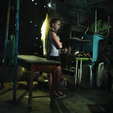 Cover imageA former student, 13, stands in a damaged school in Vuhlehirsk.